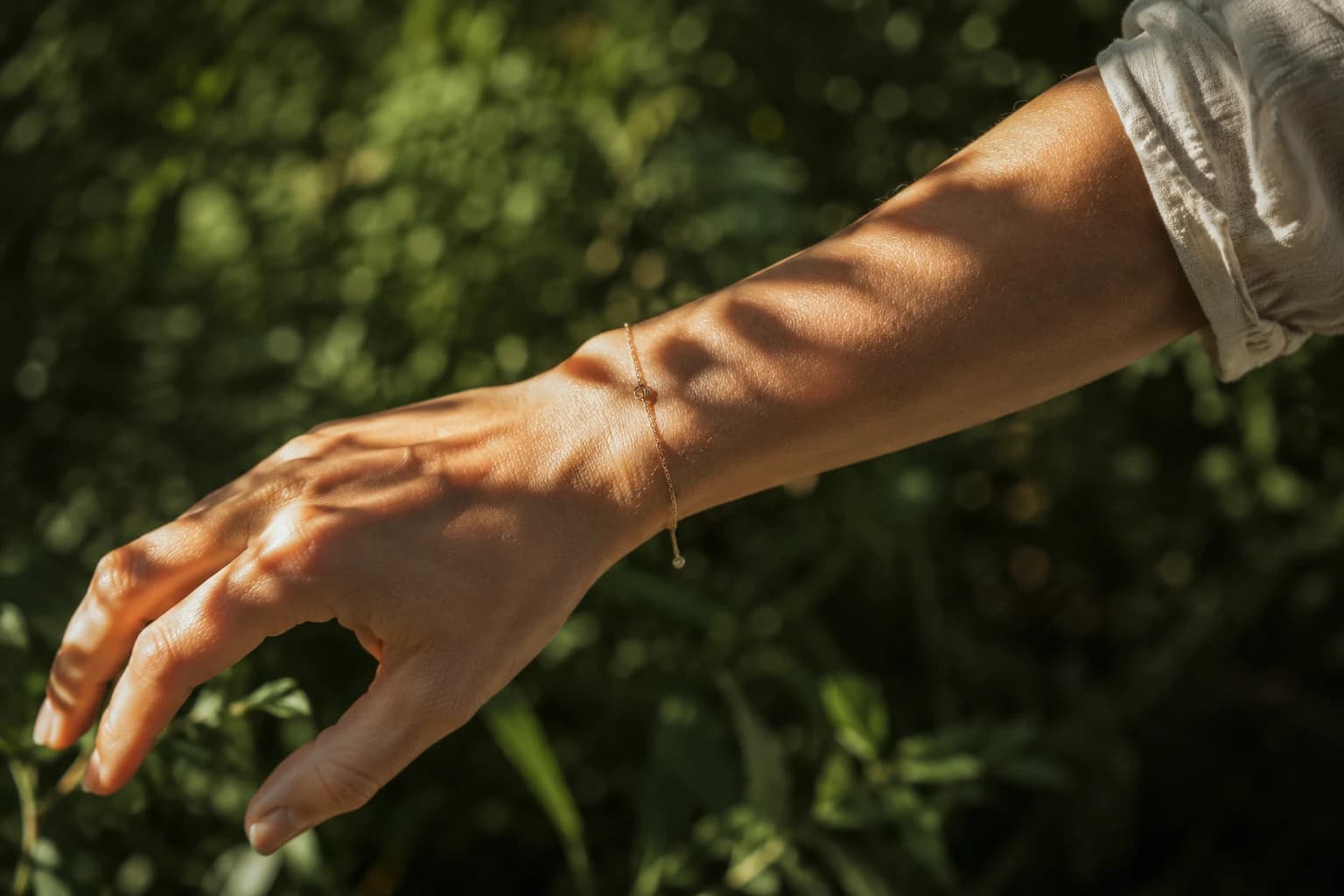 A forearm in dappled outdoor sunlight, illustrating skin sun exposure and vitamin D synthesis